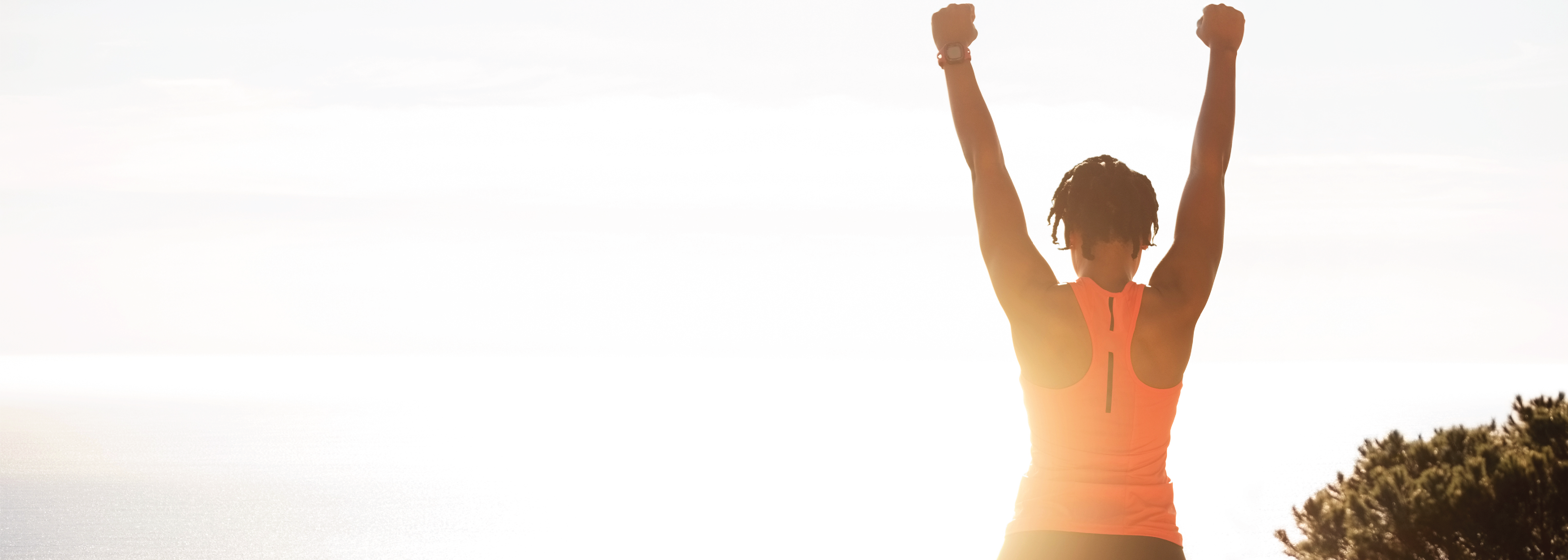 woman celebrating success with arms up in the air