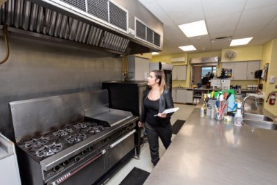 woman public health inspector inspecting a commercial kitchen