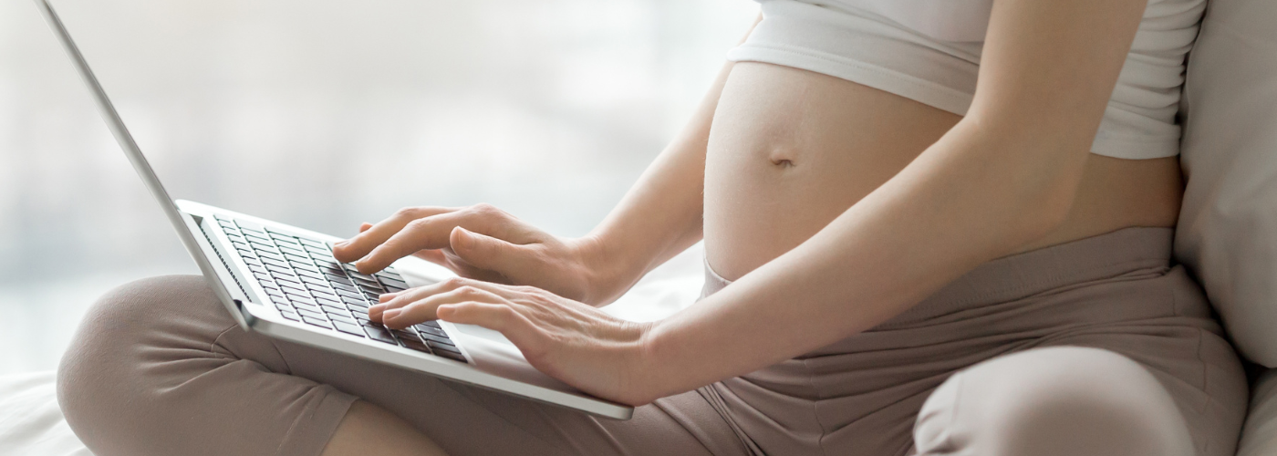 Pregnant person on a computer