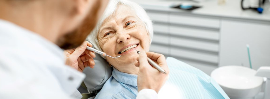 Picture of a senior woman smiling at dentist
