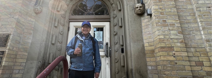 Picture of Dr. Ninh Tran standing in front of the Woodstock Location of SWPH