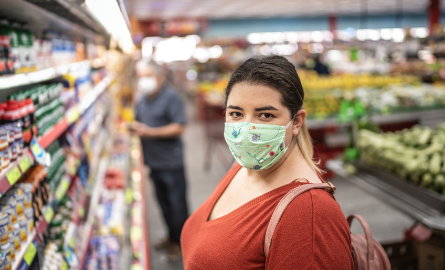 Picture of a woman at the grocery store wearing a face mask
