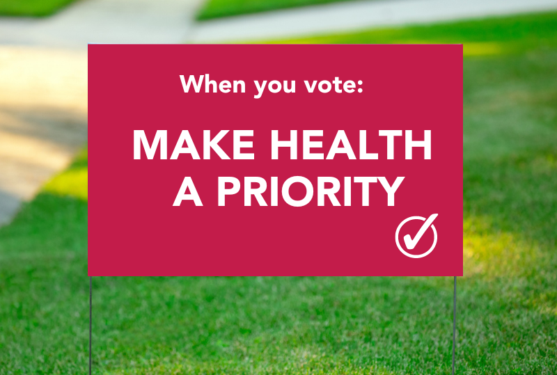 picture of a political lawn sign that says "make health a priority"