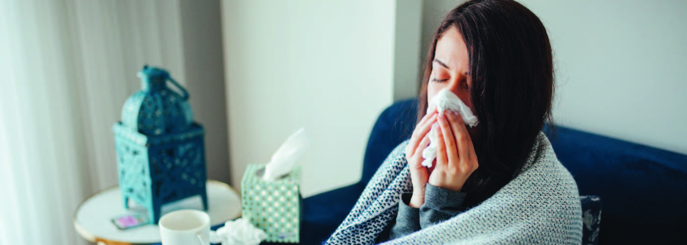 Woman blowing nose because she's sick 