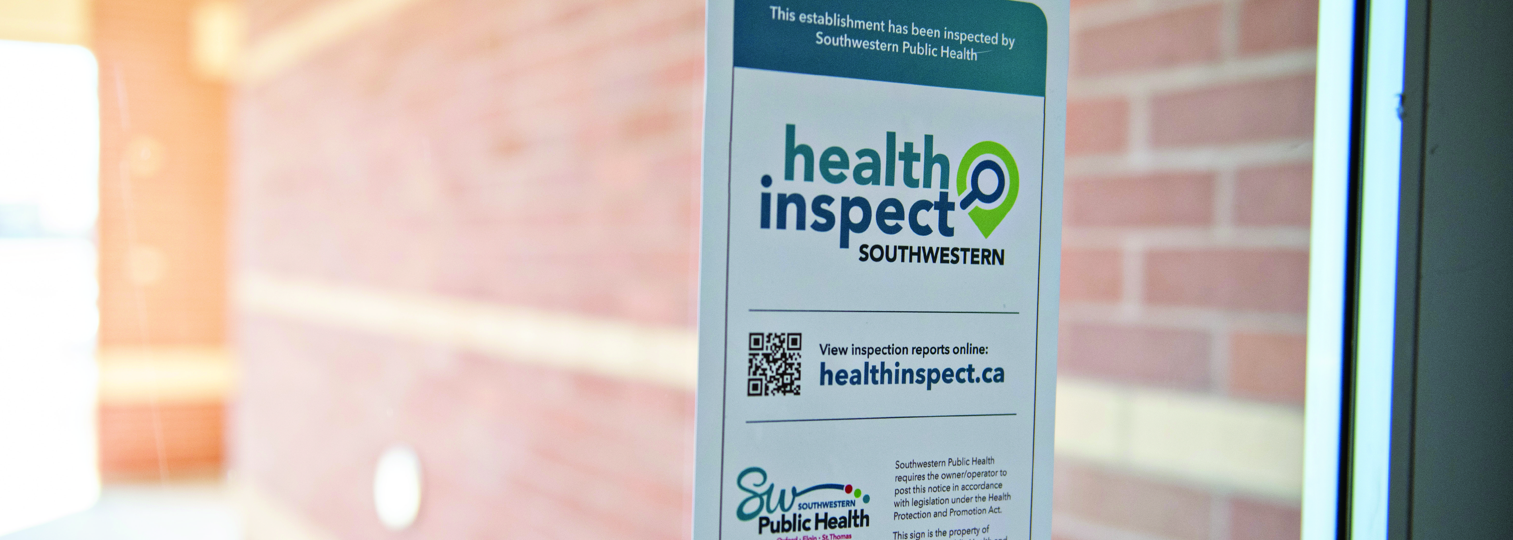 Health inspection sign on food vendor door