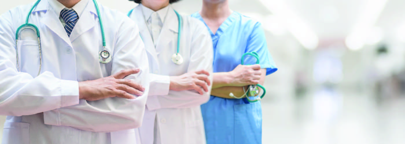 three health care providers in scrubs and uniform