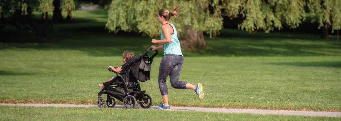 Woman pushing stroller while running