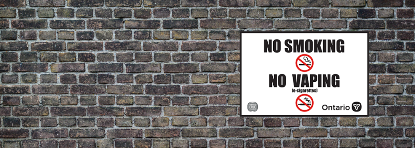 No smoking or vaping sign on brick wall