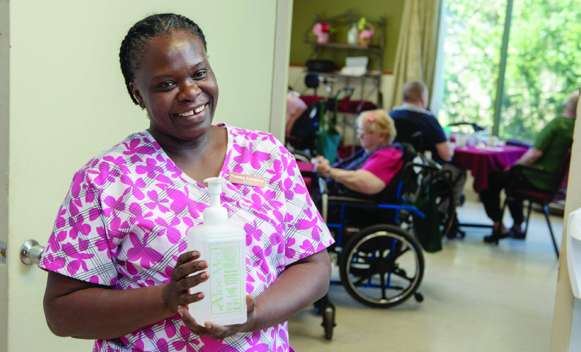 Nurse holding hand sanitizer in a long-term care home