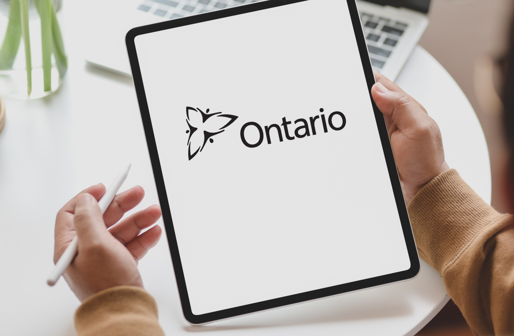 Photo of a tablet with the province of ontario logo on it