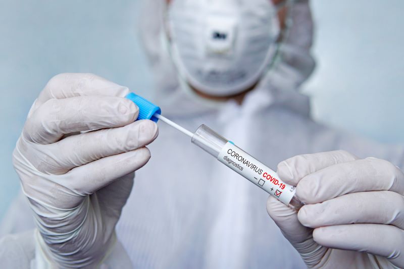 Health care provider holding a coronavirus testing swab