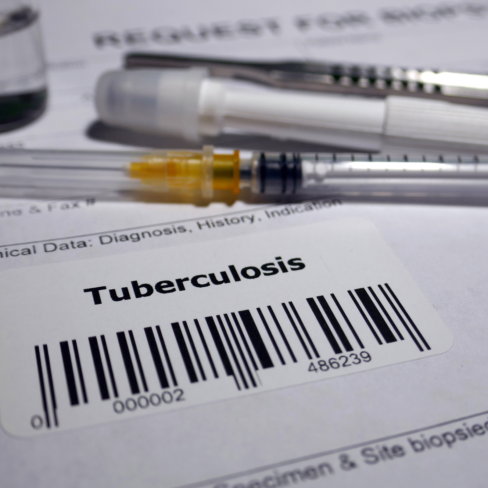 Medical paperwork and syringe with a barcode label
