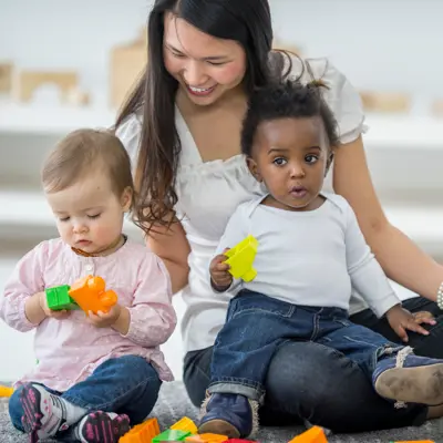 Woman playing with two babies